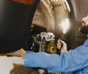 Mechanic Inspecting Brakes | Greenwich, CT