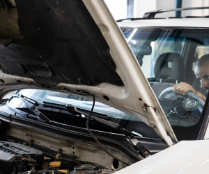 A Man in Blue Suit Checking a Car | Greenwich, CT