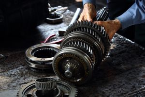 Engineer hands fixing engine power transmission gears box | Greenwich, CT